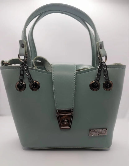 Mint Green tote bag with metallic twisted lock, crafted from premium PU leather. Features hand tote and adjustable shoulder straps, dual zippers for storage, and a sleek solid design with metallic details. Ideal for daily use or special occasions
